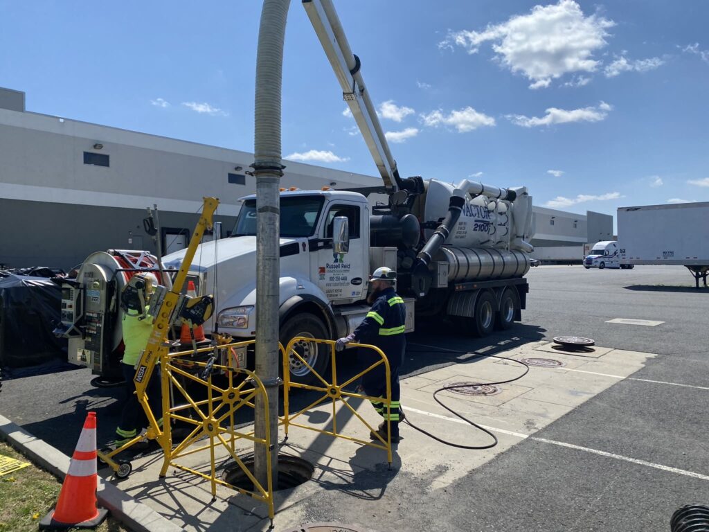 Truck performing maintenance on a hydrodynamic separator system, crucial for efficient stormwater management.