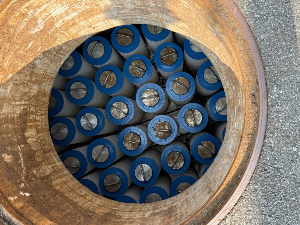 Top view of filter cartridges inside a stormwater quality treatment device, used for water filtration.